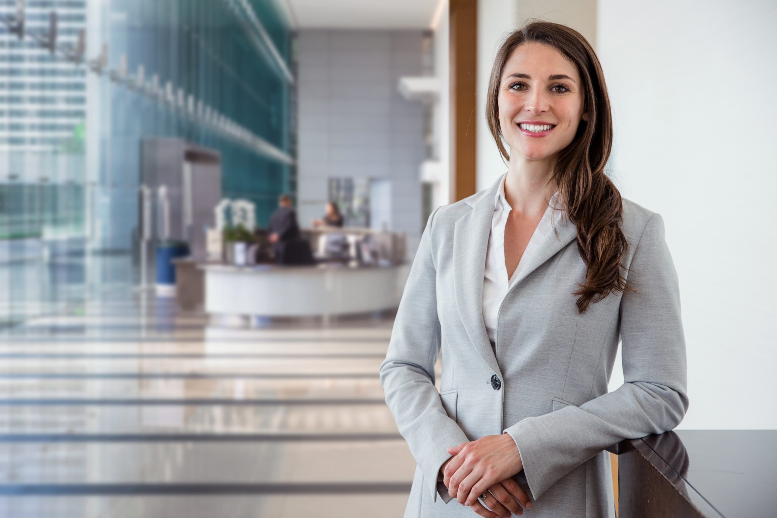 Business woman standing in office building lobby